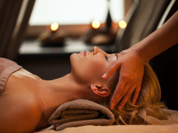 Beautiful young woman enjoys massage
